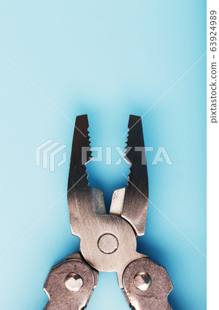 The multitool multi-function tool hovers on a blue 63924989