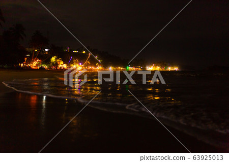 Oceanfront restaurant with lights and tables on a 63925013