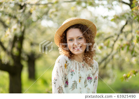 Portrait young attractive woman with curly hair in 63925490