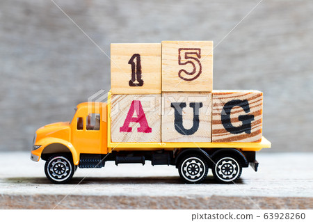Truck hold letter block in word 15aug on wood background Truck hold letter block in word 15aug on wood background 63928260