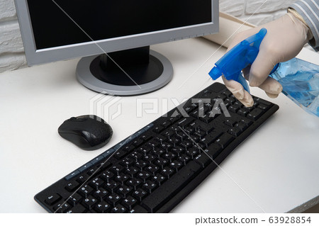 concept of cleaning or disinfecting the office - a concept of cleaning or disinfecting the office - a 63928854
