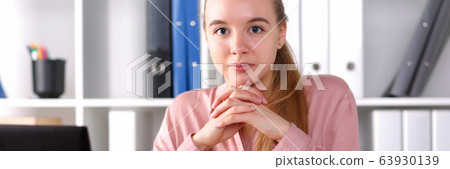 Girl sitting in workspace office in front laptop Girl sitting in workspace office in front laptop 63930139