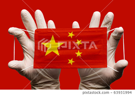 Doctor holding in gloves protection medical face mask, respiratory bandage with China national country flag superimposed on mask. Concept on red background Doctor holding in gloves protection medical face mask, respiratory bandage with China national country flag superimposed on mask. Concept on red background 63931994