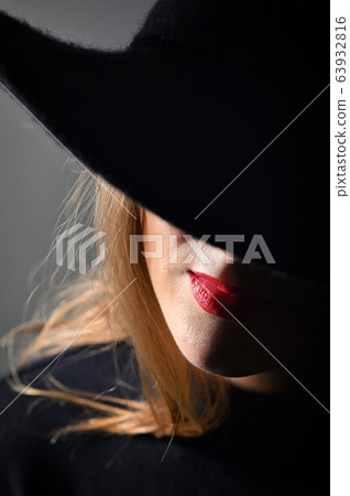 A Woman With Red Lips In A Black Hat 63932816
