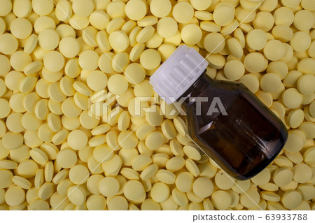jar of pills lies on other medicines. Drugs, painkillers, colds Closeup 63933788