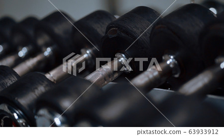Row of barbells in a gym Row of barbells in a gym 63933912