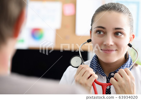 Therapist removes headphones from stethoscope Therapist removes headphones from stethoscope 63934020