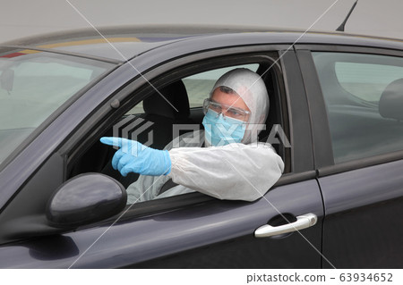 Protected driver in car wearing glasses, mask and Protected driver in car wearing glasses, mask and 63934652