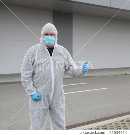 Protected worker wearing glasses, mask and gloves 63934654