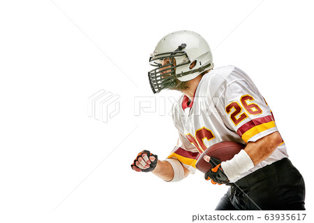American football player posing with ball on black background. Super Bowl concept. Concept American football, portrait American, Motivator. Black white background, copy space. Isolate 63935617
