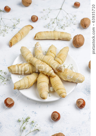 Traditional Azerbaijan holiday Novruz cookies mutaki on white plate on light background 63935710