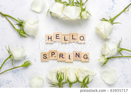 Spring card with white roses and flowers on light background,top view Spring card with white roses and flowers on light background,top view 63935717