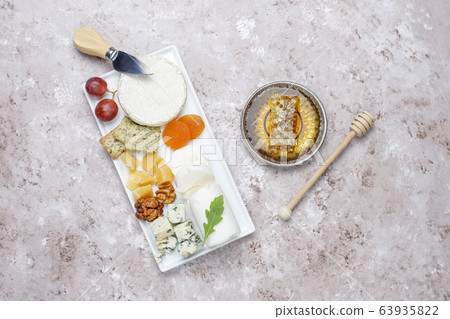 Various types of cheese on light brown background,top view Various types of cheese on light brown background,top view 63935822