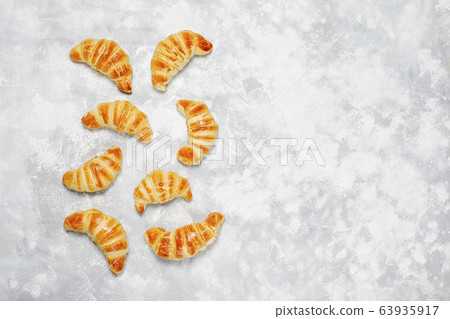 Fresh tasty homemade croissants on grey-white background. French pastry Fresh tasty homemade croissants on grey-white background. French pastry 63935917
