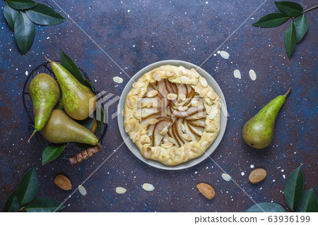 Homemade pear galette pie with almond leaves and fresh ripe green pears Homemade pear galette pie with almond leaves and fresh ripe green pears 63936199