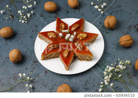 Azerbaijan national pastry pakhlava on white plate on dark background ,top view,spring new year celebration Novruz holiday. 63936510