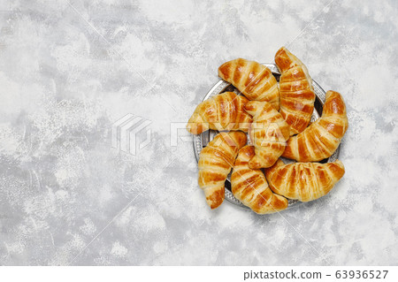 Fresh tasty homemade croissants on grey-white background. French pastry 63936527