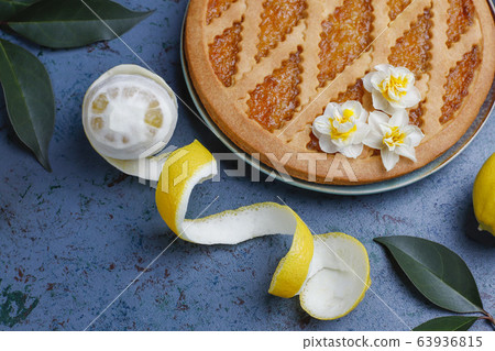 Delicious lemon pie with fresh lemons on dark background,top view Delicious lemon pie with fresh lemons on dark background,top view 63936815