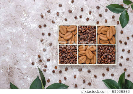 Composition with roasted coffee beans and coffe bean shaped cookies Composition with roasted coffee beans and coffe bean shaped cookies 63936883