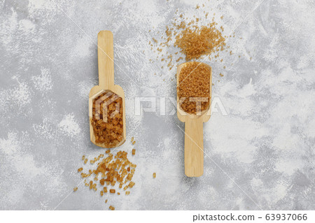 Various types of brown sugar on concrete background,top view Various types of brown sugar on concrete background,top view 63937066