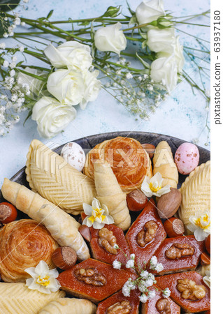 Traditional Azerbaijan holiday Novruz cookies baklavas and shakarburas on black tray plate on light background 63937180