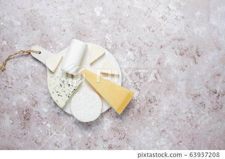 Various types of cheese on light brown background,top view Various types of cheese on light brown background,top view 63937208