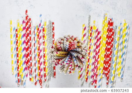 Paper straws of different colors on light background with copy space Paper straws of different colors on light background with copy space 63937243