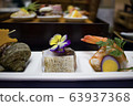 Authentic Japanese food served with floral garnish. 63937368