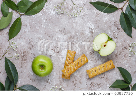 Apple puff pastry cookies in apple shape plate with fresh apples ,top view Apple puff pastry cookies in apple shape plate with fresh apples ,top view 63937730