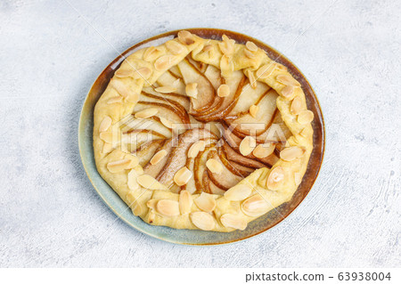 Homemade pear galette pie with almond leaves and fresh ripe green pears Homemade pear galette pie with almond leaves and fresh ripe green pears 63938004
