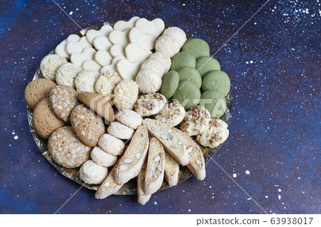 Various cookies in a wooden tray on gray background 63938017