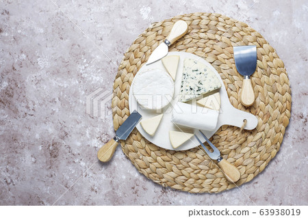 Various types of cheese on light brown background,top view 63938019