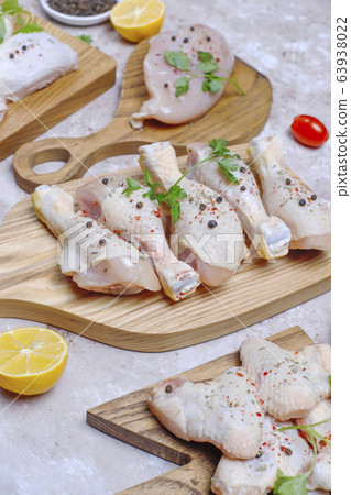 Raw chicken meat fillet, thigh, wings and legs with herbs ,spices,lemon and garlic. Top view 63938022