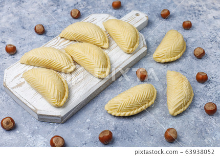 Azerbaijan national pastry shakarbura on white plate on grey concrete background ,top view,spring new year celebration Novruz holiday. 63938052