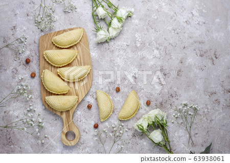 Azerbaijan national pastry shakarbura on white plate on grey concrete background ,top view,spring new year celebration Novruz holiday. 63938061
