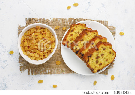 Traditional raisin cake slices with raisin on light background,top view Traditional raisin cake slices with raisin on light background,top view 63938433