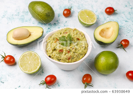 Fresh homemade hot guacamole sauce with ingredients on light background,top view 63938649