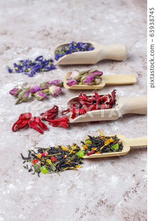 Assortment of dry tea in golden vintage mini plates.Tea types background:hibiscus,chamomile,mixed black tea,dry roses,butterfly pea tea 63938745