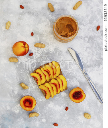 Traditional American and European summer breakfast: sandwiches of toast with peanut butter, berry,peach,fig, strawberry,raspberry, copy space top view 63938849