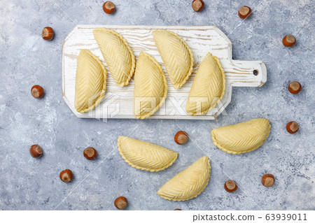 Azerbaijan national pastry shakarbura on white plate on grey concrete background ,top view,spring new year celebration Novruz holiday. 63939011