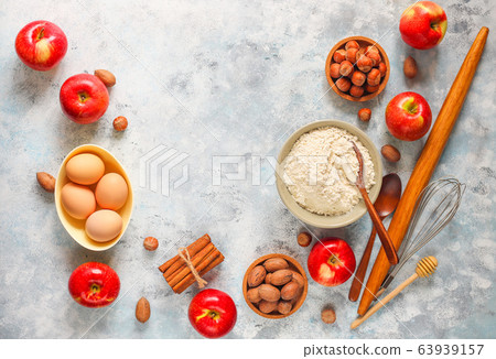 Baking concept of autumn apple pie. View from above on kitchen table. Cooking baking process with ingredients. 63939157