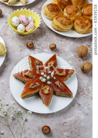 Traditional Azerbaijan sweets shakarbura,bakhlava,qogal,mutaki cookies on light background,Azerbaijan holiday Novruz background. Traditional Azerbaijan sweets shakarbura,bakhlava,qogal,mutaki cookies on light background,Azerbaijan holiday Novruz background. 63939158