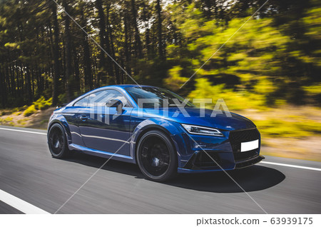 Blue luxury sedan coupe car on the highway 63939175