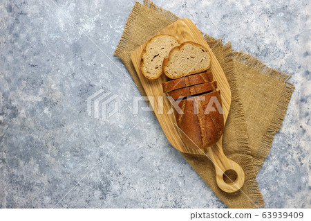 Sliced wholegrain bread on cutting board,top view 63939409