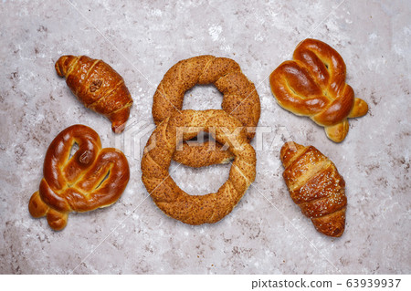 Various sweet buns on brown concrete background,top view Various sweet buns on brown concrete background,top view 63939937