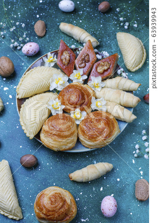 Traditional Azerbaijan holiday Novruz cookies baklavas and shakarburas on black tray plate on dark background Traditional Azerbaijan holiday Novruz cookies baklavas and shakarburas on black tray plate on dark background 63939943