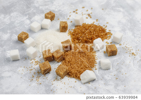 Various types of sugar, brown sugar and white on concrete background,top view Various types of sugar, brown sugar and white on concrete background,top view 63939984