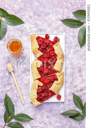 Open pie, raspberry galette. Summer berry dessert. 63940061