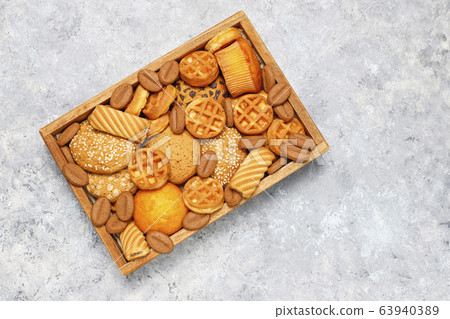 Various cookies in a wooden tray on gray background Various cookies in a wooden tray on gray background 63940389