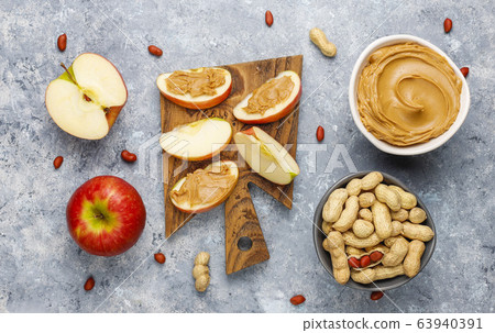 Homemade peanut butter with peanuts on grey concrete background,top view Homemade peanut butter with peanuts on grey concrete background,top view 63940391